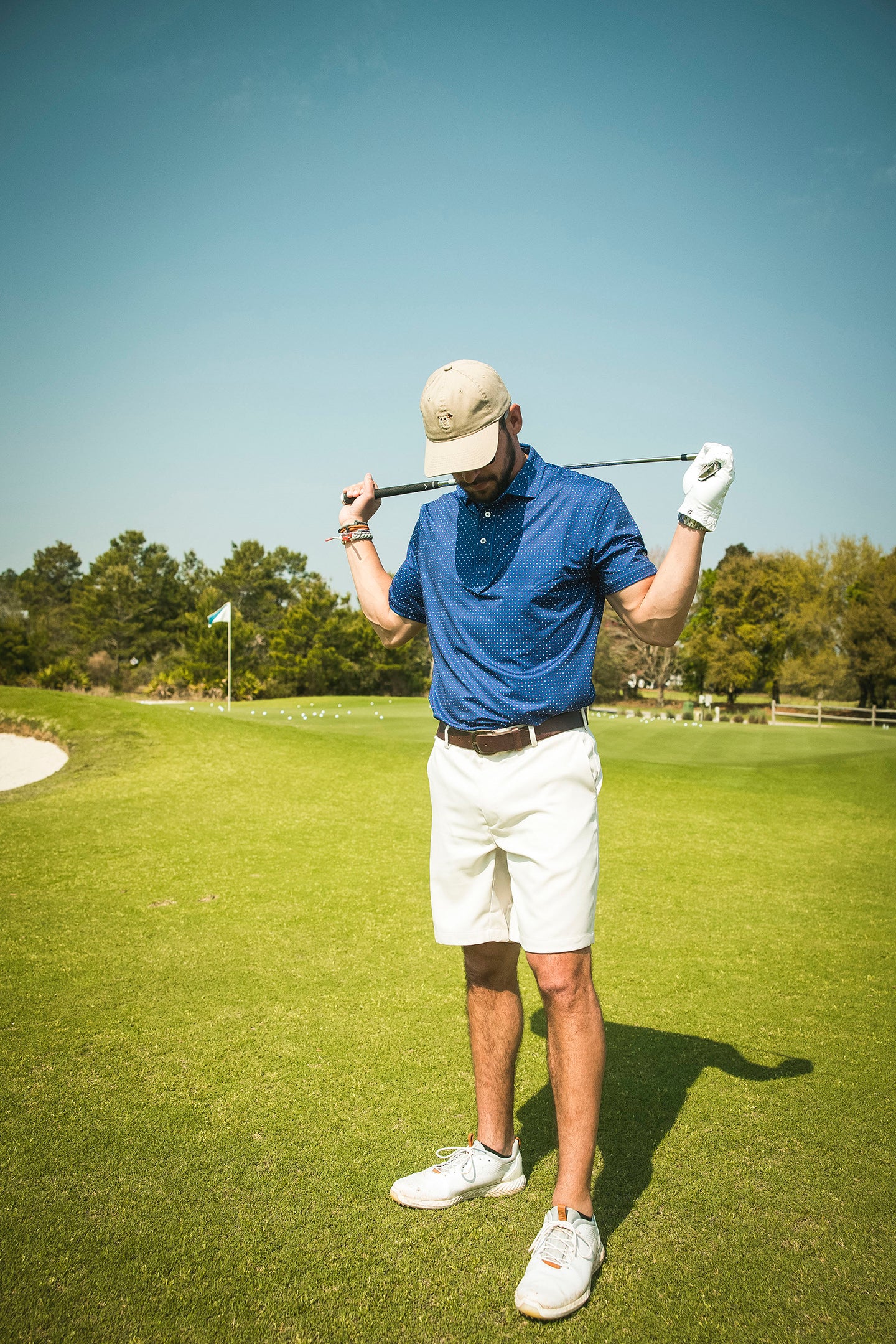 man on golf course in polo
