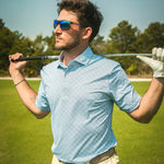 man on golf course in printed polo