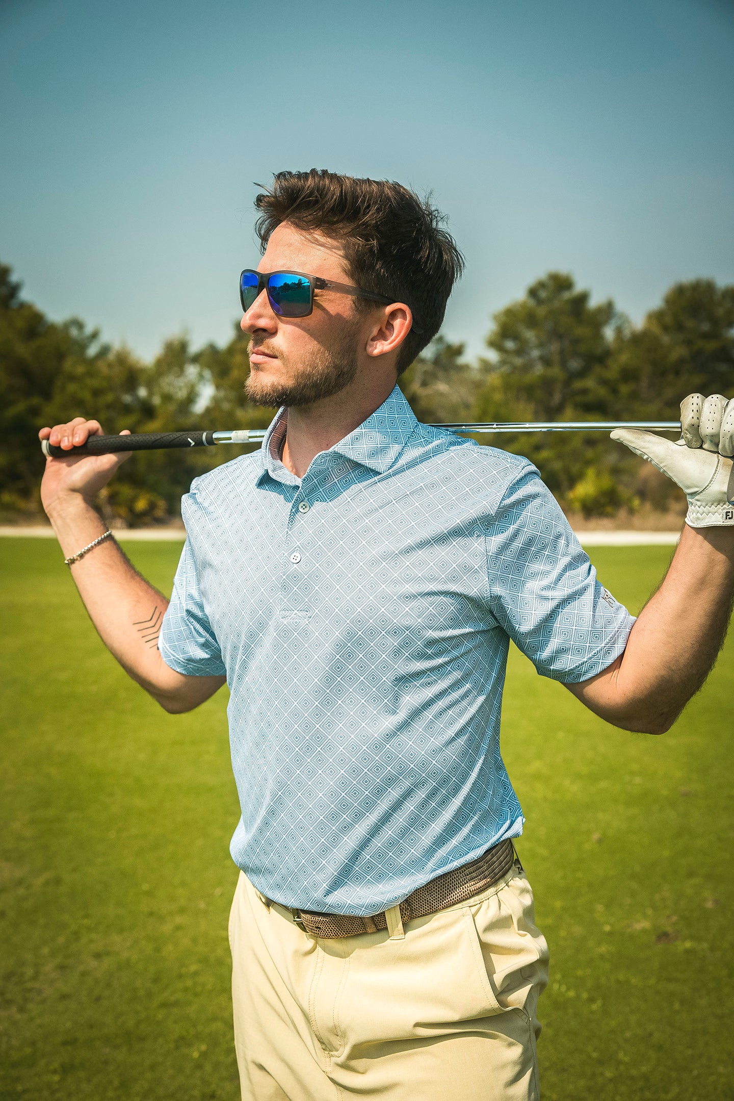 man on golf course in printed polo