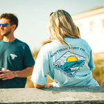 Couple on the beach in Southern Point Co tees