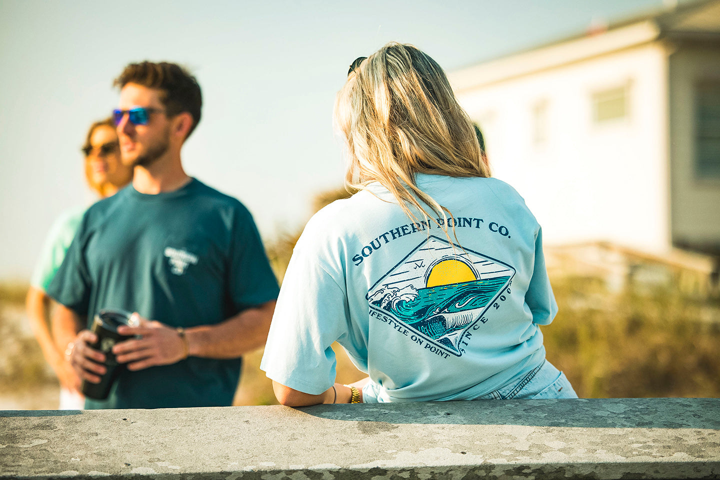 Couple on the beach in Southern Point Co tees